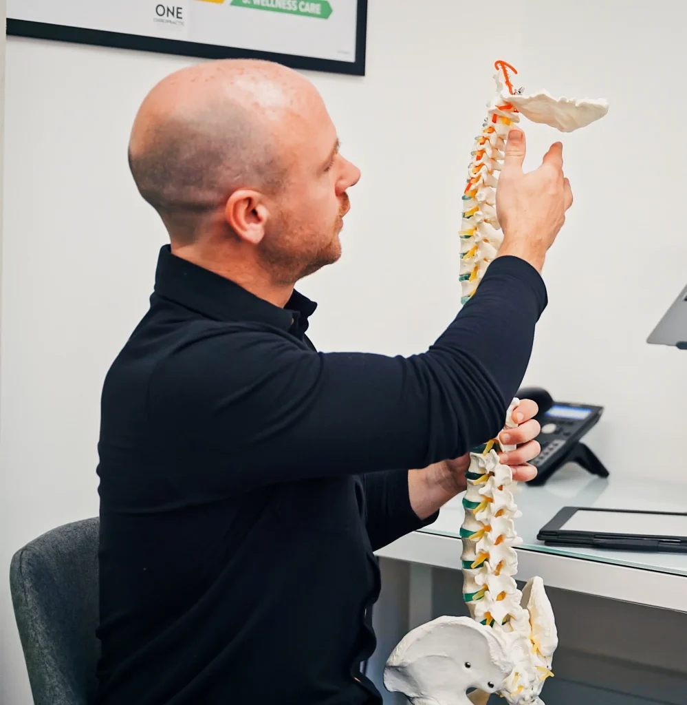 Chiropractor assessing spine posture on digital screen in Edinburgh clinic